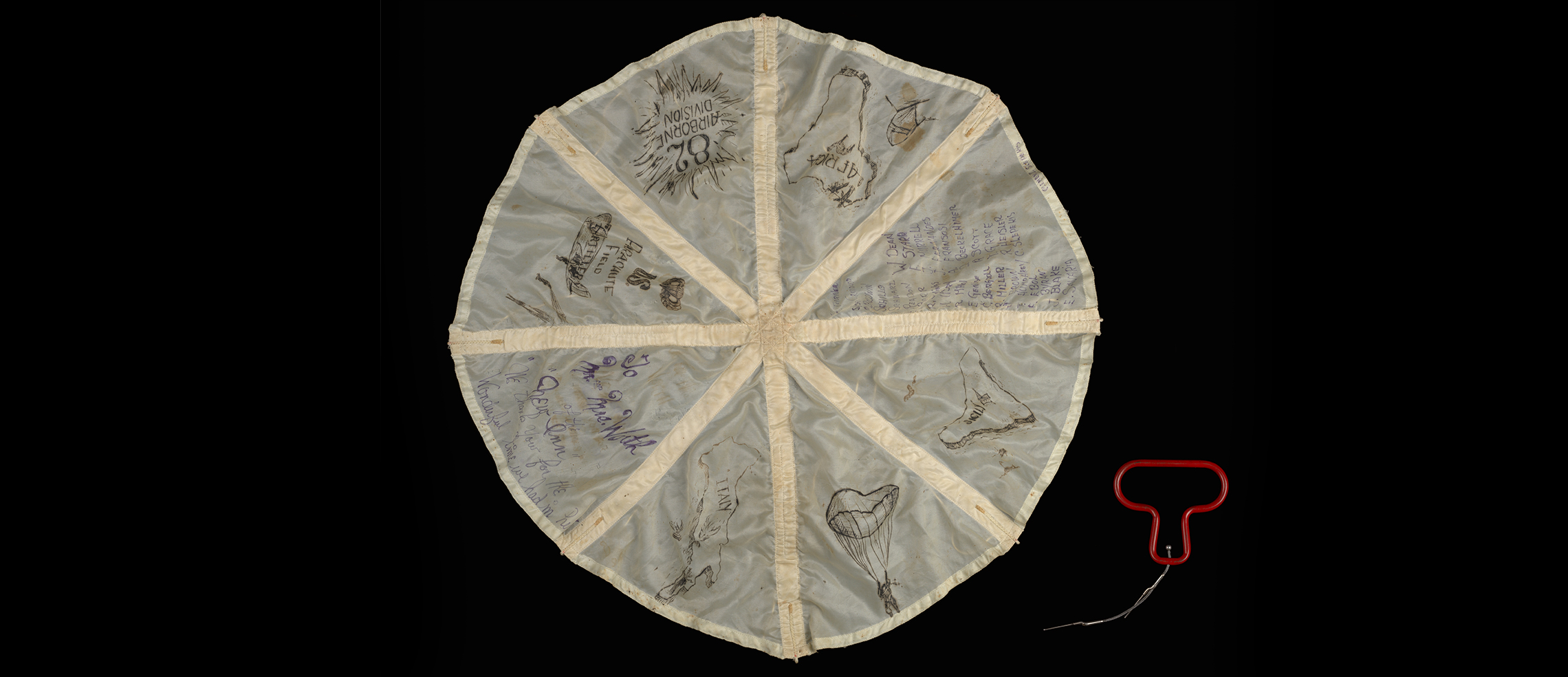 Auxiliary pilot chute signed by members of the US 82nd Airborne Division and red rip cord, from the New Inn pub, Hinckley, 