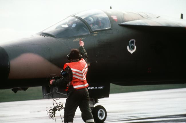 Ground personnel clears an F-111 for take-off on 14th April 1986