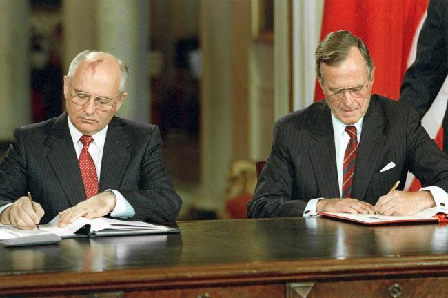 Soviet President Mikhail Gorbachev, left, and U.S. President George Bush signing bilateral documents during Gorbachev's official visit to the United States